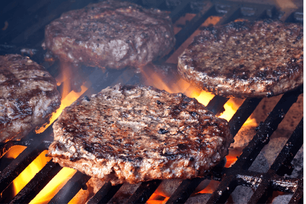 Backyard cookout guide showing how to grill burgers on a charcoal grill