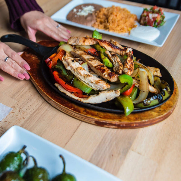 Person serving fajitas.