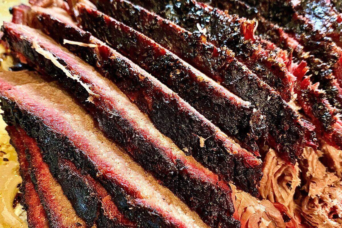 step-by-step guide to smoking brisket with trimming, seasoning, and slicing tips