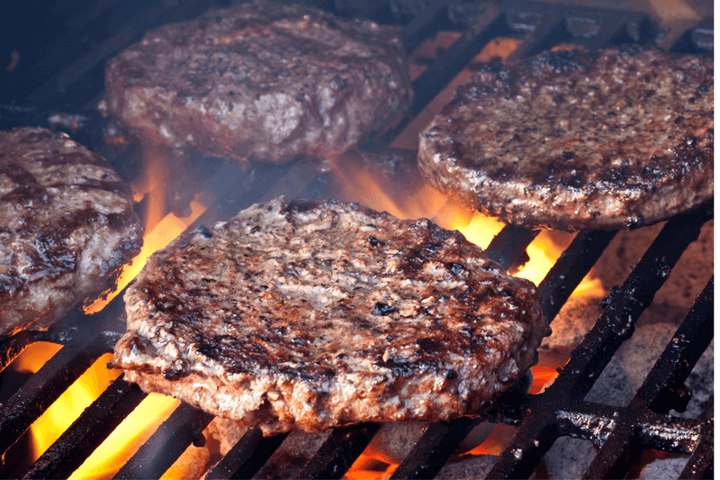 Backyard cookout guide showing how to grill burgers on a charcoal grill