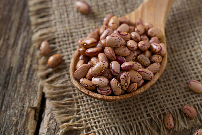 Award-winning pinto bean recipe made with SuckleBusters seasoning, featuring bold Texas flavor, all-natural ingredients, and step-by-step instructions for BBQ sides