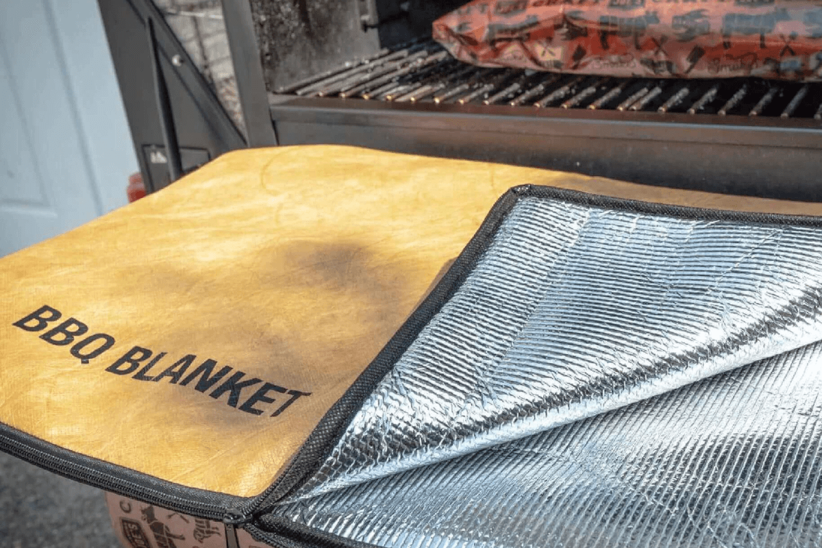 Drip EZ BBQ Meat Resting Blanket – Insulated Blanket for Brisket, Ribs, and Pork shown open with insulation pictured