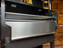 Pimp My Grill® Bodyguard Stainless Steel Grease & Paint Protector attached to the inside front of a Green Mountain Grills Ledge pellet grill.