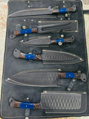 The Texan Knives Best Chef Knives Sets features five 13" forged stainless steel blades with wenge or resin handles, each in a textured black leather sheath, displayed on a stitched black leather roll-up case.