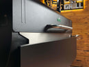 A stainless steel Pimp My Grill® Bodyguard Stainless Steel Grease & Paint Protector installed as a guard on the front of a black Green Mountain Grills Ledge 1.0 / Daniel Boone.