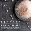 A dish of The Spice Lab Himalayan Pink Salt Coarse rests on a dark surface, its crystals scattered invitingly, accompanied by text highlighting it as the ideal seasoning for meats, vegetables, soups, and beyond. Take your cooking to new heights by pairing it with organic black Tellicherry peppercorns—both included in The Spice Lab’s exclusive Combo Pack.