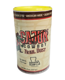 The Manly Cans BBQ Gift Can includes Cajun Cowboy Trail Dust grill seasoning—8 oz, yellow lid, cowboy graphic, Certified Cajun label. American made, fat free, no MSG—ideal for any BBQ gift set from Manly Cans.