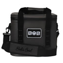 Introducing the Bob The Cooler Co. 14L "Sidekick" Flip Top Cooler Bag—a black soft-sided cooler featuring a front patch with the BOB logo and “Bobs Cool” on the shoulder strap. Designed with convenient handles, an adjustable strap, and advanced cooling technology from Bob - The Cooler Co., this bag keeps your refreshments perfectly chilled wherever you go.