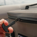 A hand pulls the black zipper tab of the Bob The Cooler Co. 14L "Sidekick" Flip Top Cooler Bag by Bob - The Cooler Co., shown in tan or gray, with a close-up focus on the zipper and fingers against a blurred background.