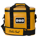 Introducing the Bob The Cooler Co. 14L "Sidekick" Flip Top Cooler Bag—a yellow soft cooler featuring black straps, a padded shoulder pad labeled "Bobs Cool," and a front patch reading "BOB." Designed by Bob - The Cooler Co., this bag offers convenience and advanced cooling technology.