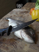 Dalstrong© Curved Boning Knife 6" Night Shark Series in use cutting food. 
