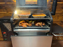 An open pellet grill featuring the Pimp My Grill® Gen2 Slide-Out Rack System with two levels of slide-out wire racks holding pans of food and roasted chickens.