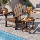 A wooden Adirondack chair and the DirectDeals 18″ Weather Resistant Outdoor Side Table - HDPE Construction with snacks, drinks, and flowers sit poolside on a stone patio, with a fire pit and potted plants in the background.