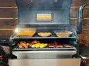 An open pellet grill featuring a Pimp My Grill® Gen2 Slide-Out Rack System - 2 Racks holding pans of roasted chicken, corn on the cob, and ribs, maximizing the smoker’s cooking space.