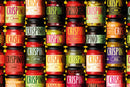 Rows of colorful jars of Taycte Famiglia Crispino Calabrese Eggplant Pasta Sauce — Melanzane Sugo are arranged closely together. Each jar features a bright, boldly colored label highlighting authentic Calabrian ingredients—like eggplant and rich Italian tomatoes—showcasing the Taycte brand’s vibrant, eye-catching display inspired by traditional cuisine.