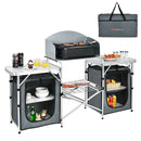 The DirectDeals Folding Camping Table with Storage Organizer features foldable tables, a cooking grill, shelves for storing food and dishes, plus a carrying bag—perfect for keeping your camping items organized.
