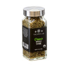 A glass jar of The Spice Lab Organic Whole Thyme by The Spice Lab, featuring a silver lid and black label, filled with dried thyme leaves—ideal for seasoning blends or adding thyme to chicken dishes. Net weight: 8 oz (226 g).