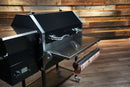 Recteq RT-590 with a Pimp My Grill® Tactical Stainless Folding Front Shelf, featuring a paper towel roll attached to the underside.