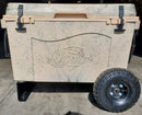 A beige speckled cooler with a fish skeleton design sits on concrete beside a detached Taiga Coolers Ice Chest Wheel Kit for 55quart and 88 quart coolers by Taiga Coolers.