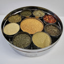 The Spice Wheel Italian Spice Wheel by Spice Wheel is a round spice box featuring nine sections, each filled with an assortment of classic Italian dried herbs and spices—including oregano, red pepper flakes, and granulated garlic—neatly displayed against a white background. It’s the ideal spice organizer and makes a perfect kitchen gift for anyone who loves authentic Italian flavors.