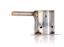 A cylindrical metal object with a side-mounted tube and multiple holes, bearing burn marks and welds, stands upright on a reflective white surface—representing the Smokin Brothers Fire Pot for Ceramic Ignitor (2025 Release), an excellent choice for upgrading your pellet grill or as a replacement component in your Smokin Brothers fire pot assembly.