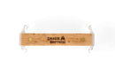 The Smokin Brothers Grid Lifter features a rectangular wooden handle engraved with the Smokin Brothers name and grill logo, attached to white metal brackets at each end. Seen from above against a white background, this tool is the ideal addition to your collection of Smokin Brothers accessories.