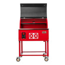 The Smokin Brothers “30” Premier Plus Barn-B-Que Grill by Smokin Brothers is a red metal smoker grill, perfect for outdoor kitchens, featuring a hinged black lid that opens to reveal a spacious cooking grate inside. Two wheels on the front legs provide easy mobility, while the front control panel and decorative white barn-style graphics add charm to its design. This grill is ideal for pellet cooking enthusiasts.