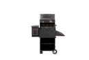 The Smokin Brothers Inferno Grill - 20″ by Smokin Brothers is a black portable pellet grill with a control panel on the left, a closed lid on top, and an open front revealing the grates. Engineered for serious searing power and wood-fired performance, this grill is equipped with wheels and features a lower storage shelf. The image has a plain white background.