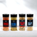 Four spice jars from The Spice Lab stand in a row, labeled Nashville Hot Chicken, Key West Seasoning, Everything + More, and Chicago Chop, against a white background—showcasing The Spice Lab Taste of America Seasoning Collection. This bold assortment of American-inspired blends is perfect for grilling seasoning and everyday cooking.