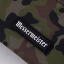 A close-up of the Messermeister Camouflage Knife Roll - 5 Pocket shows its camo fabric and a black patch with "Messermeister" in white gothic-style lettering.