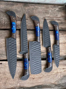 The Texan Knives Handmade Damascus Steel Chef Knife Set features five elegant knives with matte gray blades and wooden handles with blue resin accents—a perfect wedding or Valentine’s Day gift for any cooking enthusiast.
