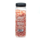 A clear rectangular plastic container filled with pink Himalayan salt crystals is shown from the back, featuring a black lid and a label with product information and a barcode—part of The Spice Lab Himalayan Pink Salt Coarse & Organic Black Tellicherry Peppercorns Combo Pack by The Spice Lab.