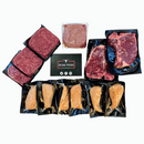 A Dude Food Dude Meat Box featuring vacuum-sealed Boneless Skinless Chicken Breasts, American Ground Beef, and Kansas City Strip Steaks is displayed around a Dude Food branded card on a white background.
