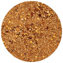A close-up, top-down view of a round container filled with The Spice Lab Ghost Pepper Sea Salt (Naga Jolokia), a coarse, brown spice blend by The Spice Lab featuring visible bits of dried herbs and red pepper flakes. This extreme heat seasoning delivers bold flavor and intense spice in every sprinkle, thanks to the fiery kick of Naga Jolokia.