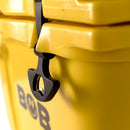 Close-up of a black latch securing the lid of a yellow Bob - The Cooler Co. 25QT "Wingman" Hard Cooler, with the partial brand name BOB visible on the side.