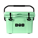 Sure! Here’s a rewrite using your product data: A mint green Bob The Cooler Co. 25QT "Wingman" Hard Cooler featuring a black handle and black latches. The front of this insulated cooler displays the text "BOB" with a smiley face and lightning bolts inside the letter O.