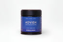 A small black jar topped with a black lid features a blue label that reads "World Spice Advieh Handcrafted Blend, Sweet • Warm • Floral, Net Wt. 1.55oz (44g), World Spice." This beloved Persian spice blend, popular in Iranian cuisine, is displayed on a white background.