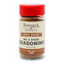 A 3 oz (85 g) jar of Powerful Pepper Company Steak Seasoning No. 5 with a red lid. This gourmet blend offers a bold yet approachable flavor with a hint of black garlic. The label indicates it is spicy, with a heat level of 1/10.