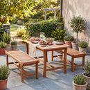 A DirectDeals 2-Person Outdoor Wood Bench with Slatted Seat - Set of 2 provides cozy patio seating beside a wooden table set for a meal, surrounded by potted plants on a sunny stone patio.