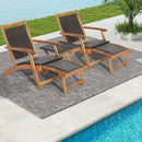 The 3 Pieces Patio Rattan Folding Lounge Chair Set of 2 with Acacia Wood Table by DirectDeals sits on a textured outdoor rug beside a pool, ideal for relaxing outdoors, with green grass and a palm plant in the background.
