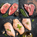 Dude Food’s Dude Food Guys Meat Box features an artful assortment of raw T-bone steak with herbs and a fork, tender Kansas City Strip Steaks, and boneless chicken breasts seasoned with herbs, salt, oil, and peppercorns—beautifully arranged on a dark stone surface.