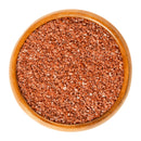 A wooden bowl filled with medium grain, reddish-brown salt crystals of The Spice Lab Hawaiian Red Alaea Sea Salt by The Spice Lab, renowned for its earthy flavor, viewed from above on a white background.