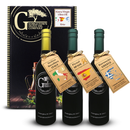 Three bottles from the Georgetown Olive Oil Co 3 Bottle Extra Virgin Olive Oil Gift Set are displayed in front of an elegantly designed gift box labeled Georgetown Olive Oil Co. Each bottle’s tag highlights its origin—Italy, Spain, or Greece—and showcases that it contains extra virgin olive oil from a fresh harvest. This premium gift set from Georgetown Olive Oil Co. is an ideal choice for gourmet gifts or anyone who appreciates high-quality olive oils.