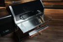 Recteq RT-590 | Pimp My Grill® Tactical Stainless Folding Front Shelf attached to the front of a pellet grill with a roll of butcher paper hanging underneath.
