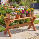 The DirectDeals Outdoor Wood Bench Set of 2 - 36 Inch Backless Patio Seating displays multiple potted flowers in vibrant pink, orange, white, and purple, set amid green grass and a stone path.