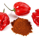 Three whole red habanero peppers surround a small pile of The Spice Lab Scorpion Chile Powder, highlighting the intense heat of this fiery spice blend from The Spice Lab, all set against a clean white background.