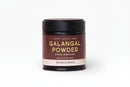 A small jar of World Spice Galangal Powder, featuring a brown label and black lid with the words "Peppery • Citrusy • Warm," "Single Ingredient," and "World Spice" displayed, sits on a plain white background—an essential Southeast Asian aromatic ideal for adding depth to Thai curries.