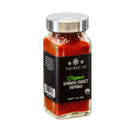 A transparent glass jar of The Spice Lab Organic Spanish Sweet Paprika, featuring a silver lid and a black label that shows the product name and net weight of 1.9 ounces—ideal for enhancing your favorite BBQ rubs or as a versatile sweet paprika pimenton in any kitchen.