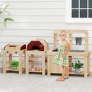 A young girl in a green plaid dress stands next to the DirectDeals 3-Piece Outdoor Kitchen Set Mud Kitchen with Separate BBQ Grill and Pizza Oven-Natural, set outdoors by a white wall and window.