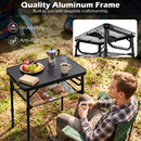 A man enjoys fruit, coffee, and snacks outdoors at a DirectDeals 3-Height Folding Camping Table with Large Storage Net & Handle. Text highlights the heavy-duty, anti-rust frame and underside close-up.